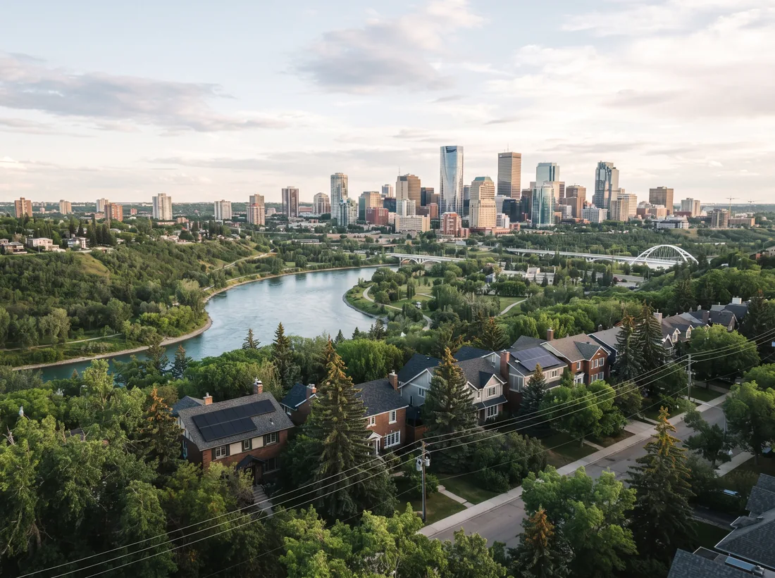 View across the North Saskatchewan River valley to downtown Edmonton with solar homes along the top of the bank