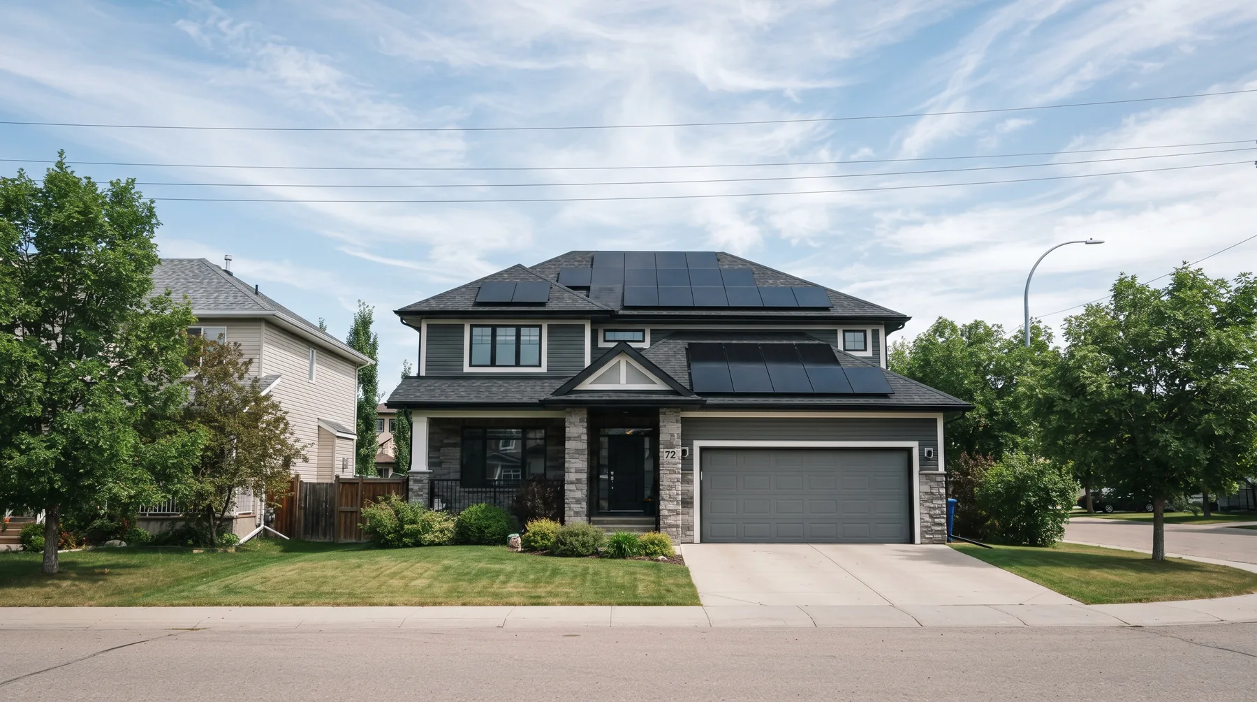 All-black solar panels across the south and west roof planes of a two-storey home in Edmonton